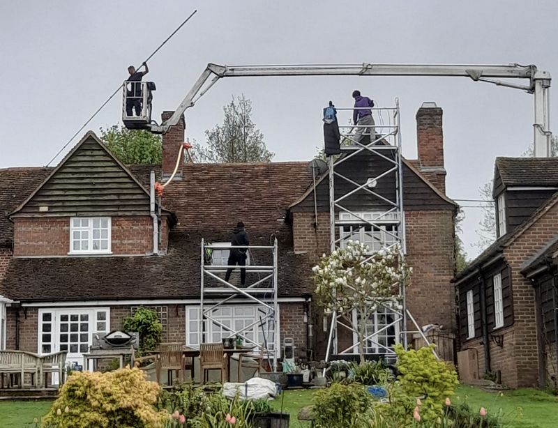 The Roof Moss Cleaners using cherry picker and scaffolding to clean roof safely and professionally in Hilperton, Wiltshire